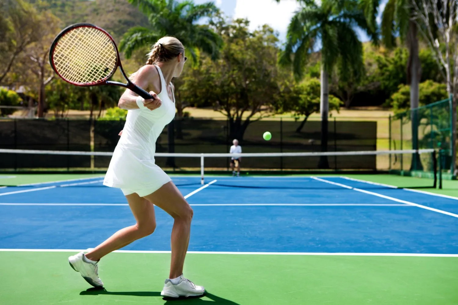 Adult group tennis lesson on an outdoor court in Los Angeles