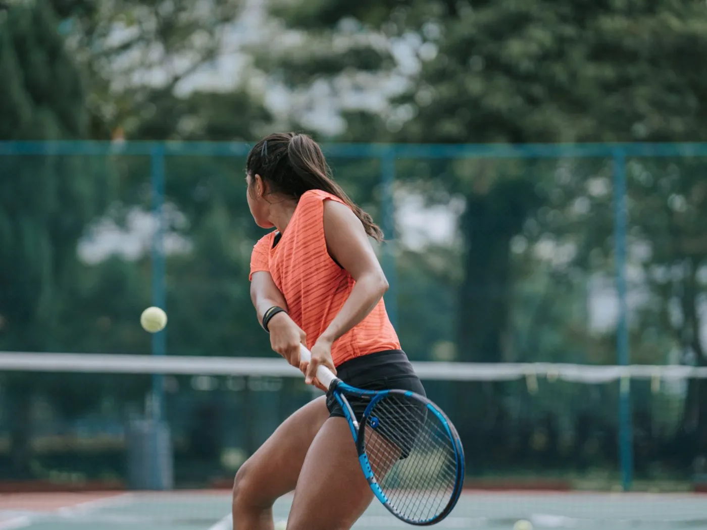 Player striking a backhand during live ball point play